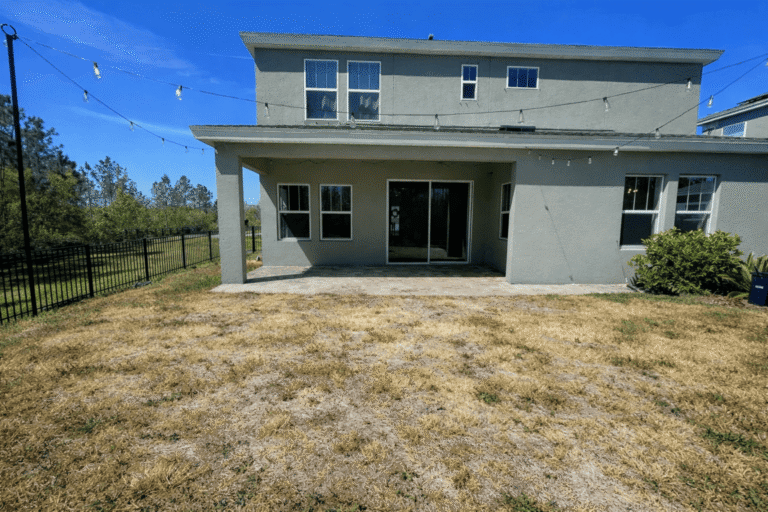 Backyard area before paver patio and fire pit installation in Tampa Bay