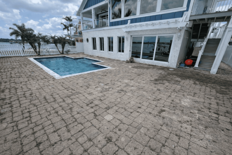 Waterfront pool deck area before travertine installation in Tampa Bay