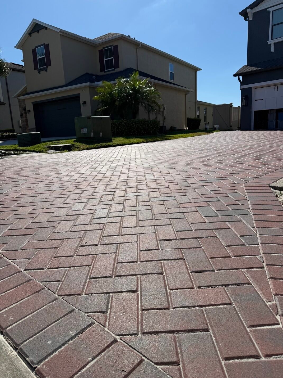 Brick pattern paver driveway installation at a Tampa Bay residential property