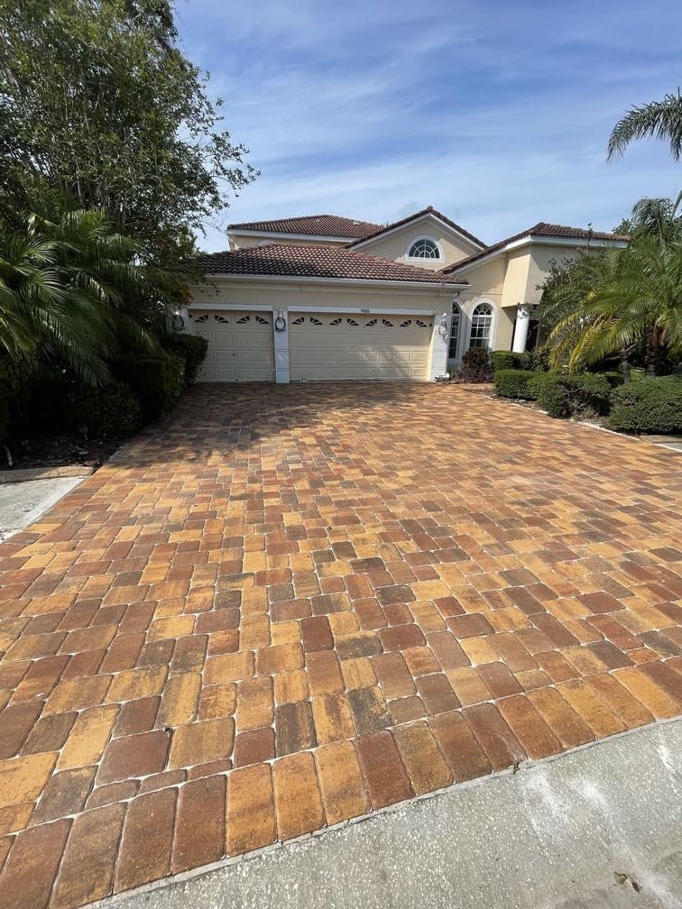 Warm tone residential paver driveway installation in Tampa Bay
