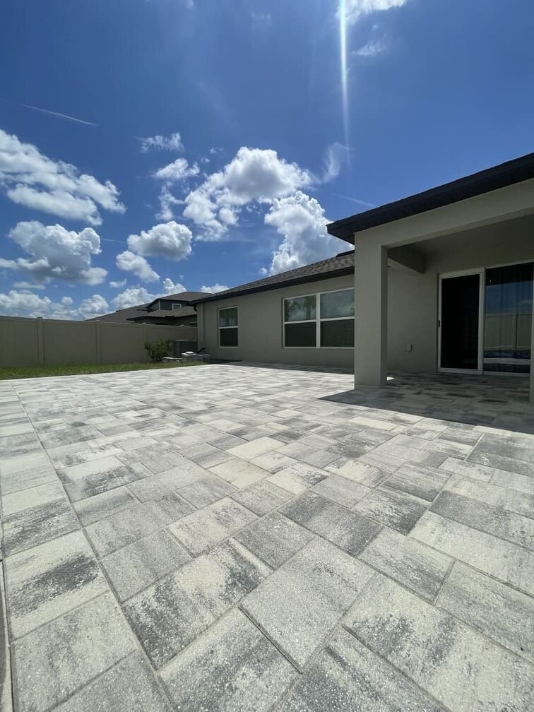Completed backyard paver patio at a residential property in Tampa Bay