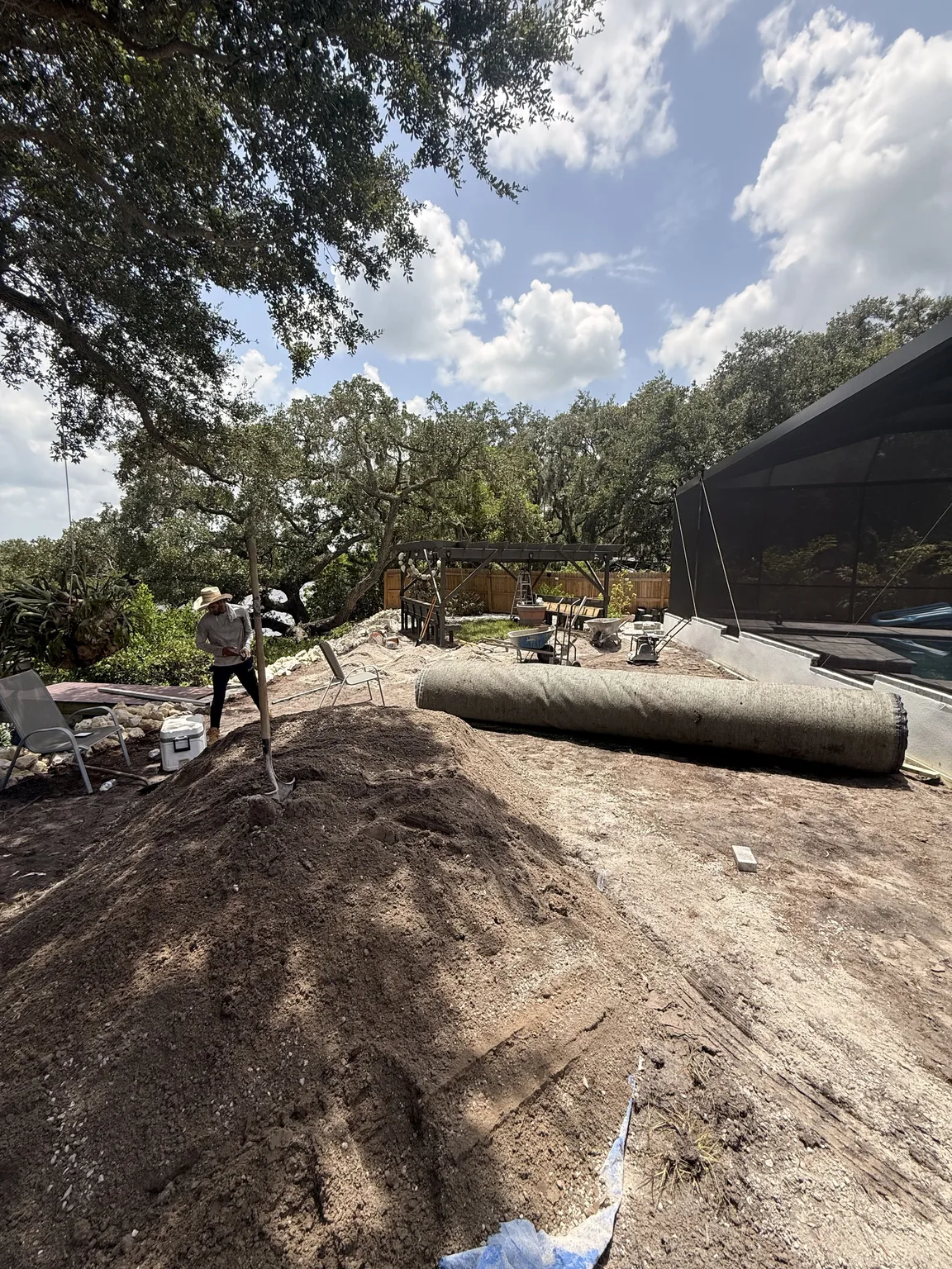 Residential backyard during ground preparation for artificial turf in Tampa Bay