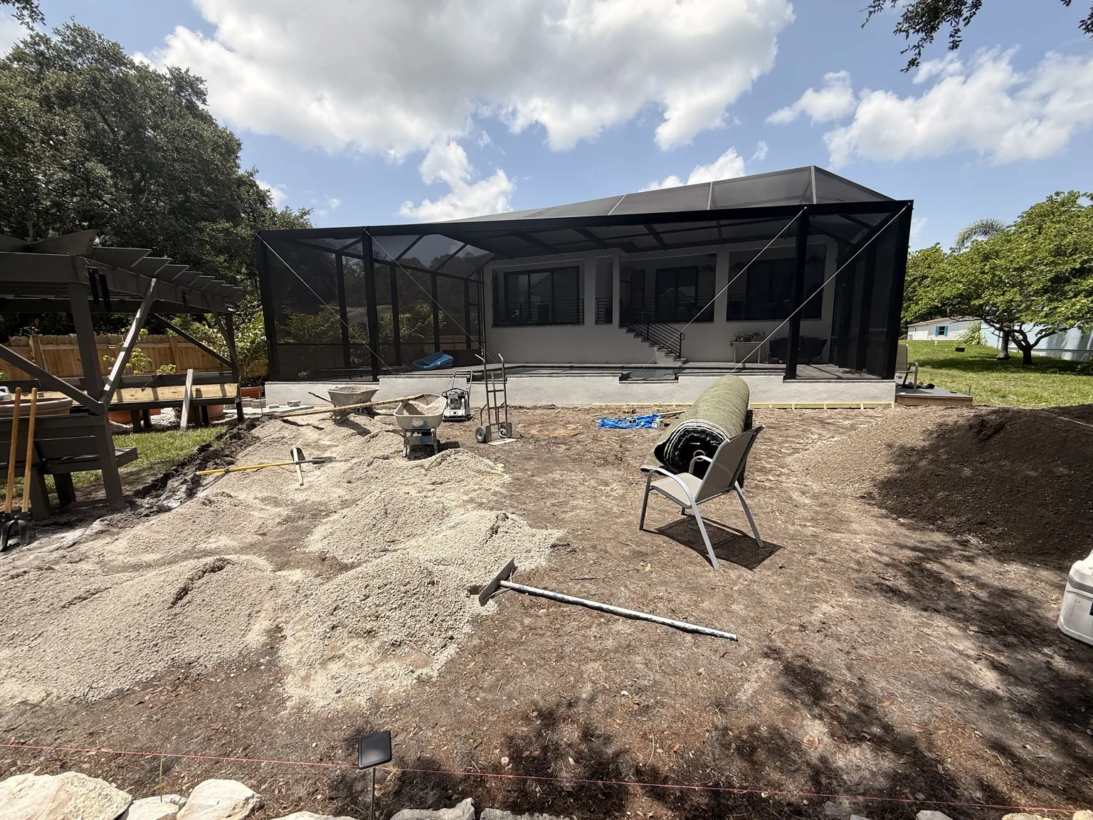 Backyard ground preparation before artificial turf installation in Tampa Bay