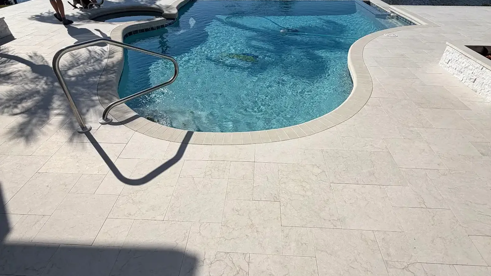 travertine vs concrete pavers shown in a real Tampa Bay outdoor project