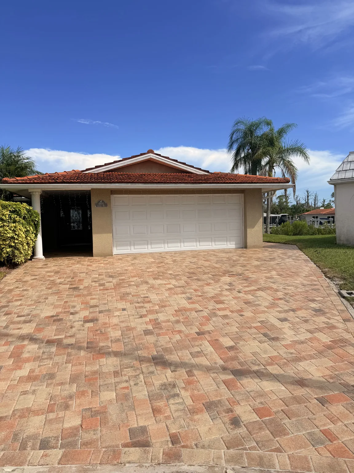 Residential paver driveway after cleaning and sealing in Tampa Bay