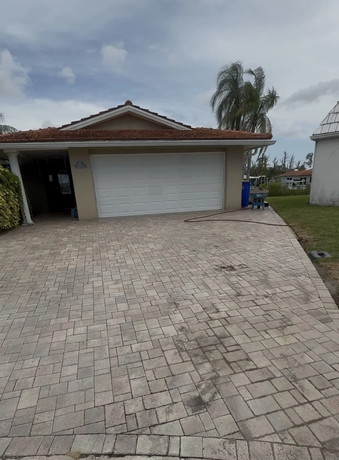 Residential paver driveway before cleaning and sealing in Tampa Bay