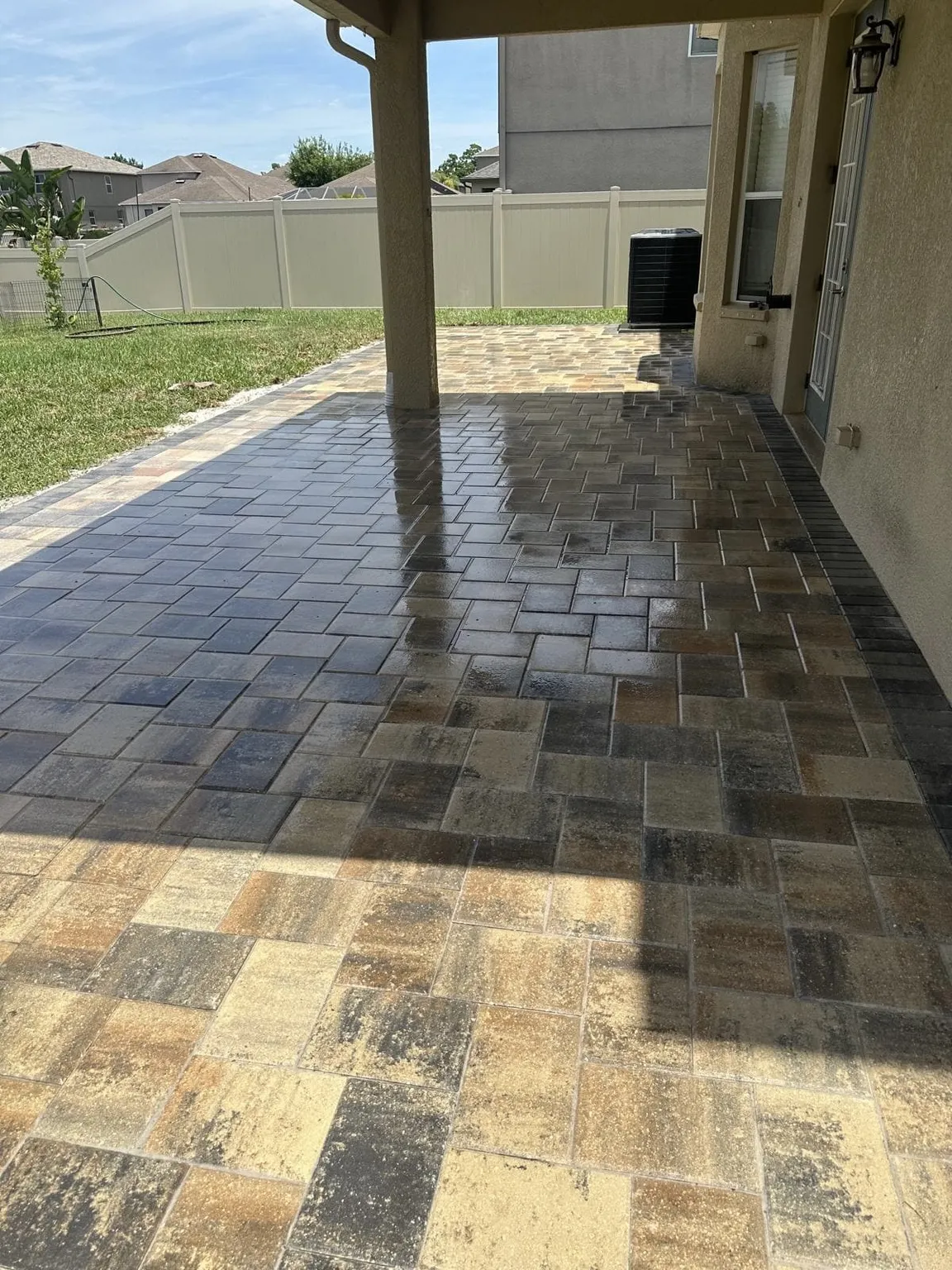 Backyard paver patio after cleaning and sealing in Tampa Bay